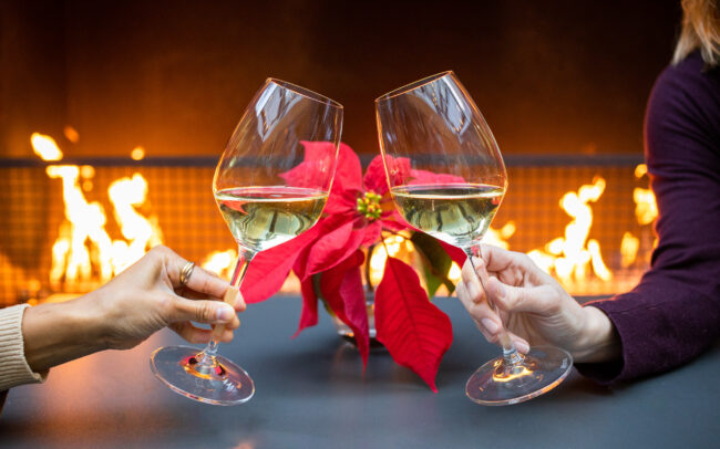 Holiday Cheers in front of fireplace